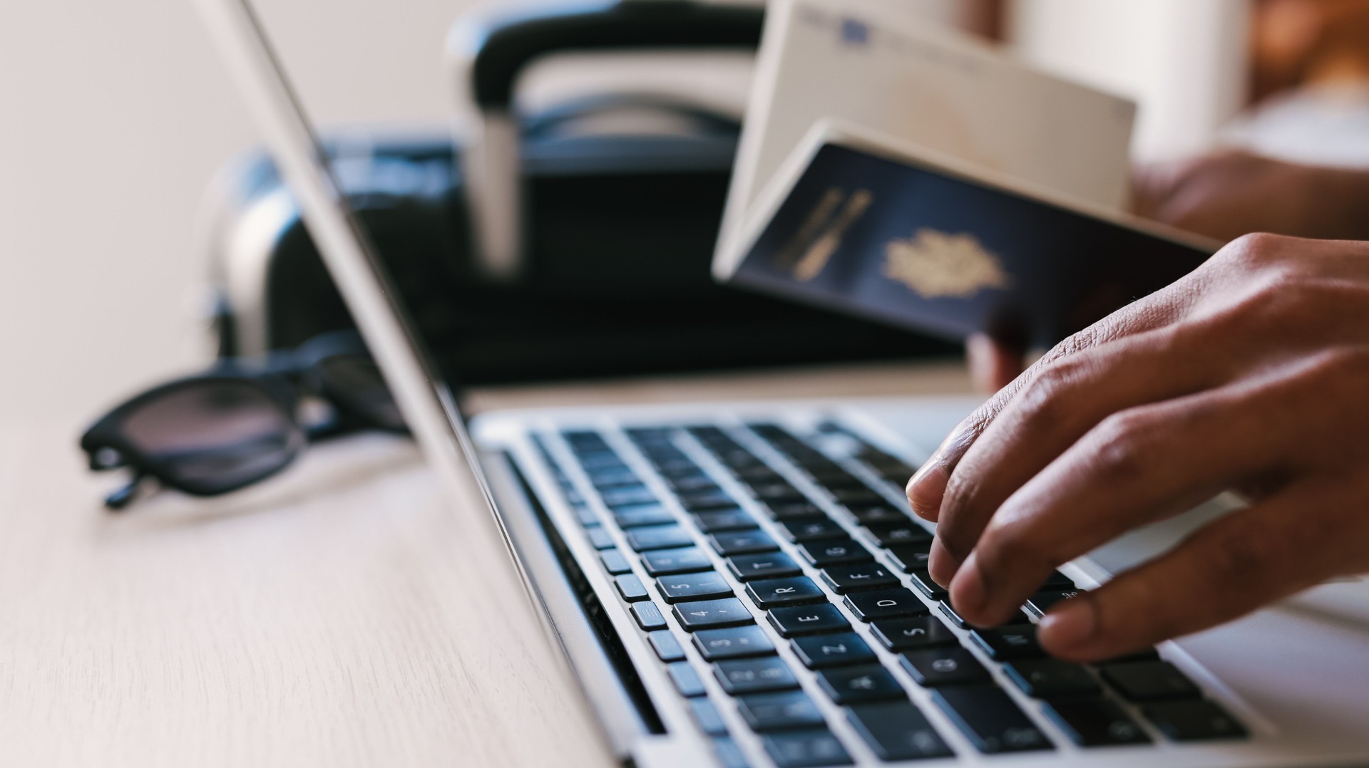 Passport and man on laptop booking vacation, vacation or flight to tropical destination and reading hotel website, concept of Travelling