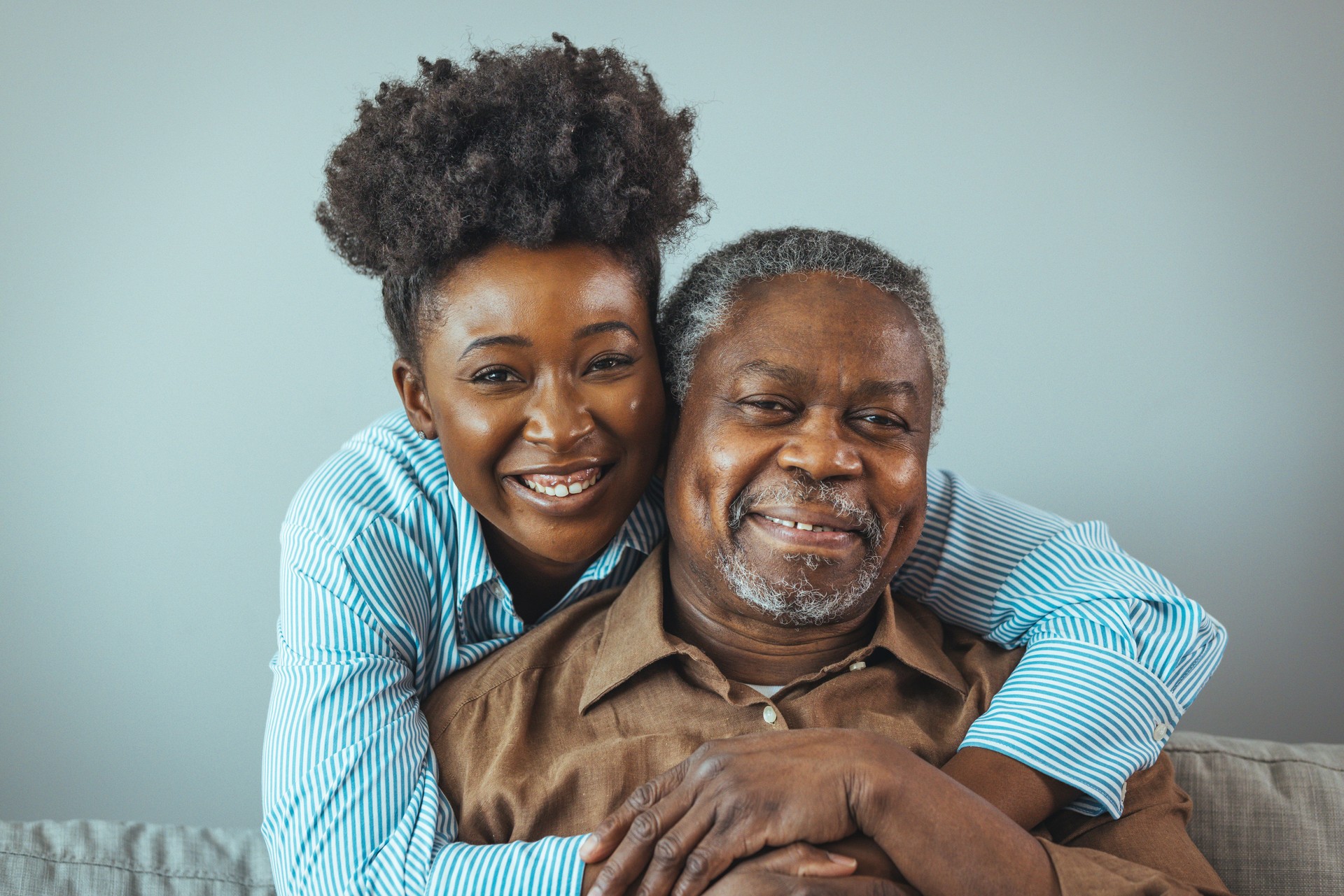 Portrait of a daughter holding her elderly father